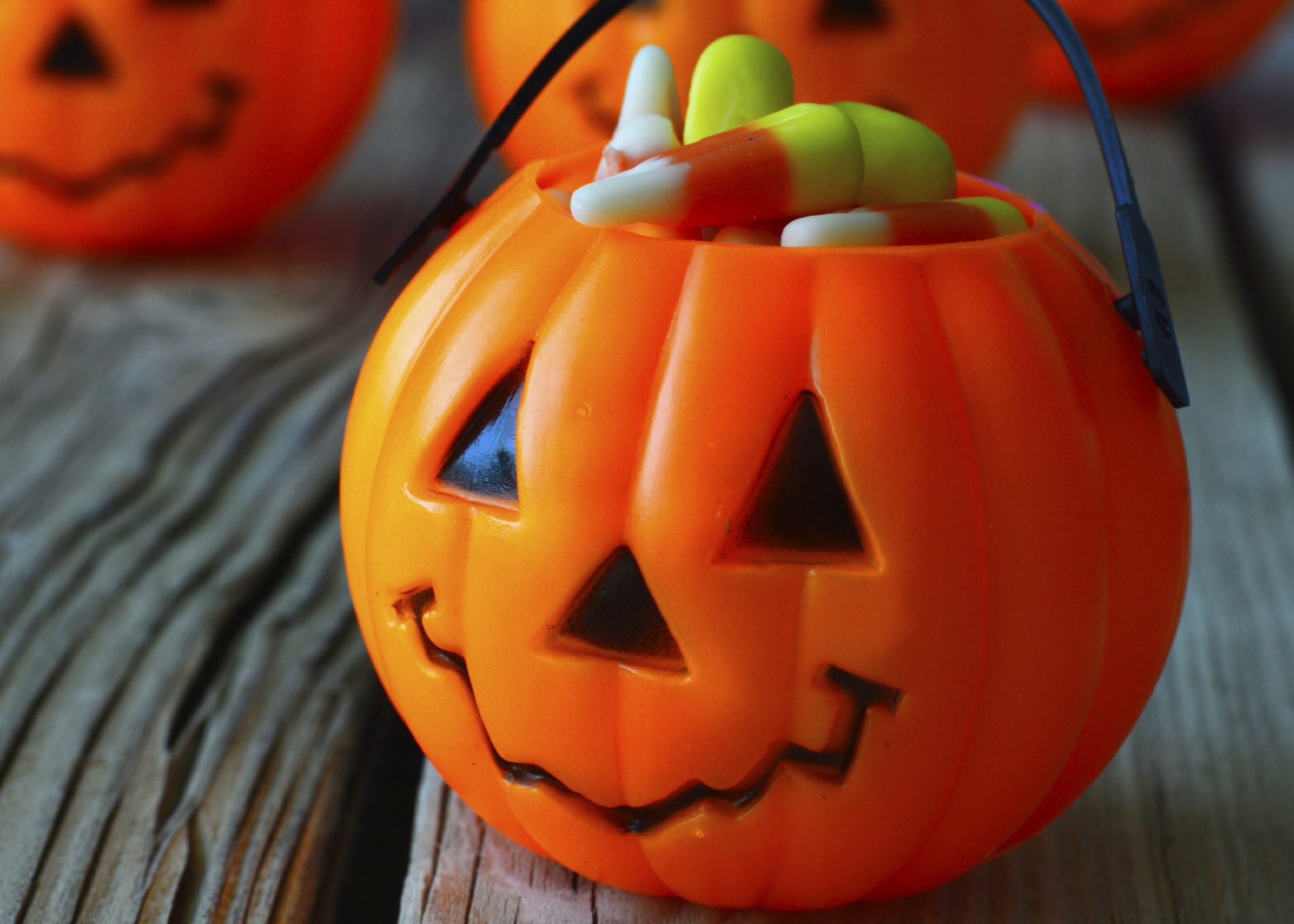 bucket of candy corn in the shape of a pumpkin